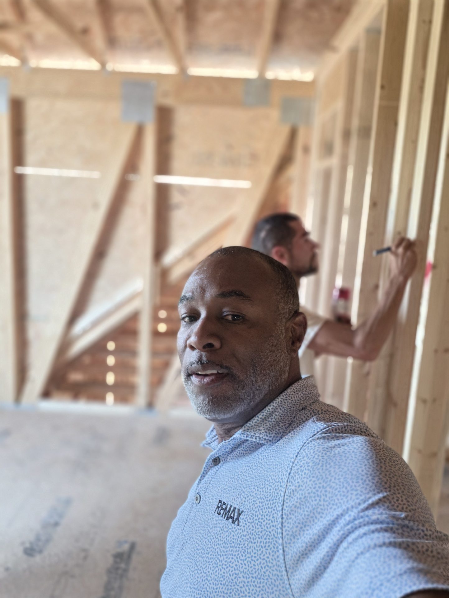 Lavell Jackson walking the framed interior with the builder