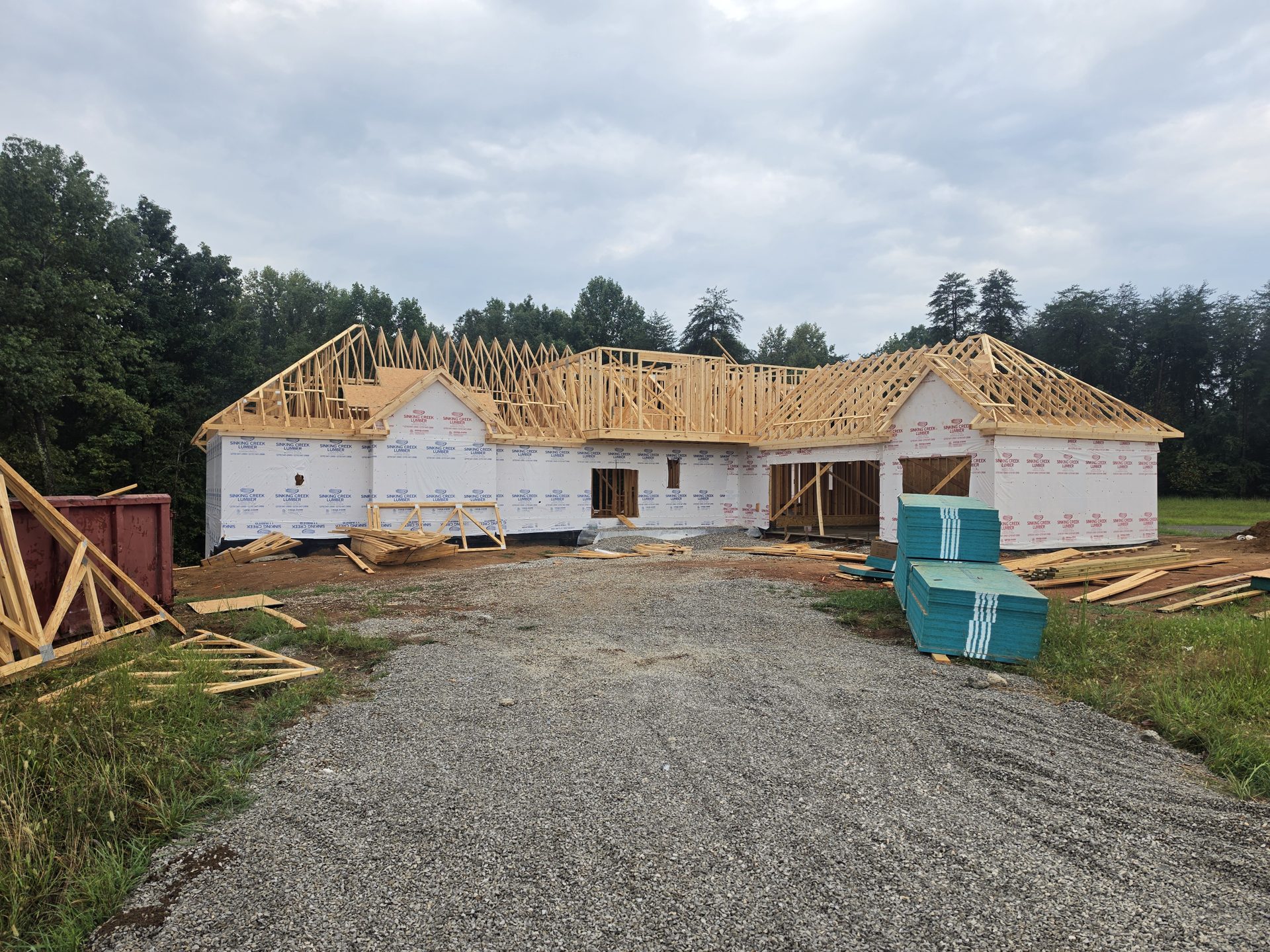Early framing on the Kennedy family's new home with roof trusses going up