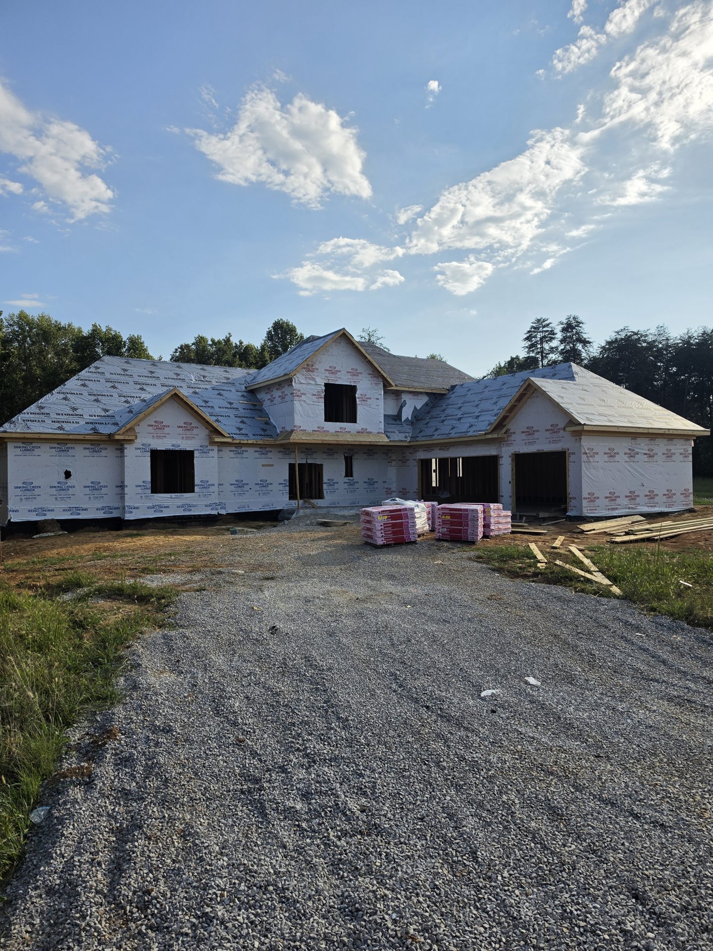 The Kennedy home with roof sheathing and house wrap installed